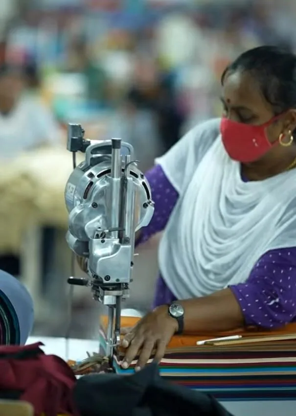 Precision cutting through stacked fabric layers